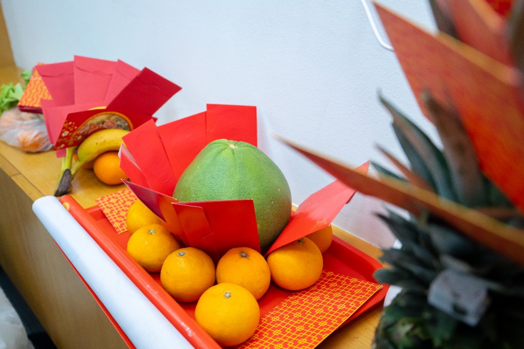 Traditional fruit and red packet offerings for the office grand opening