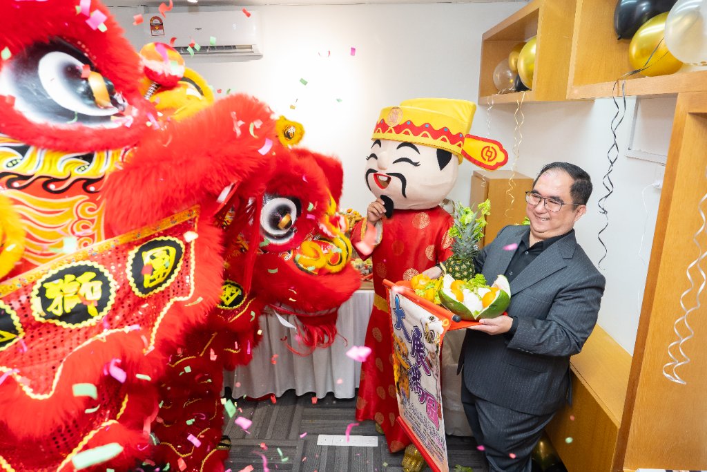 Dougles Chan receiving a prosperity offering tray during the lion dance blessing