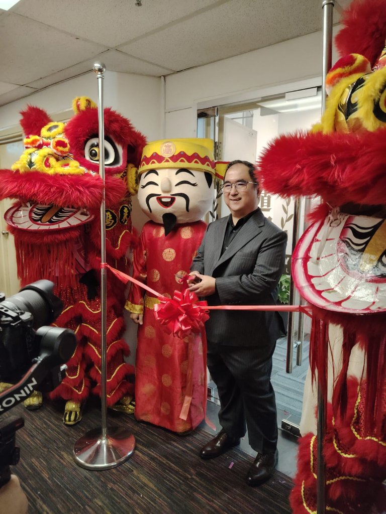 Dougles Chan cutting the ribbon at the grand opening of the new office in Mont Kiara, Kuala Lumpur